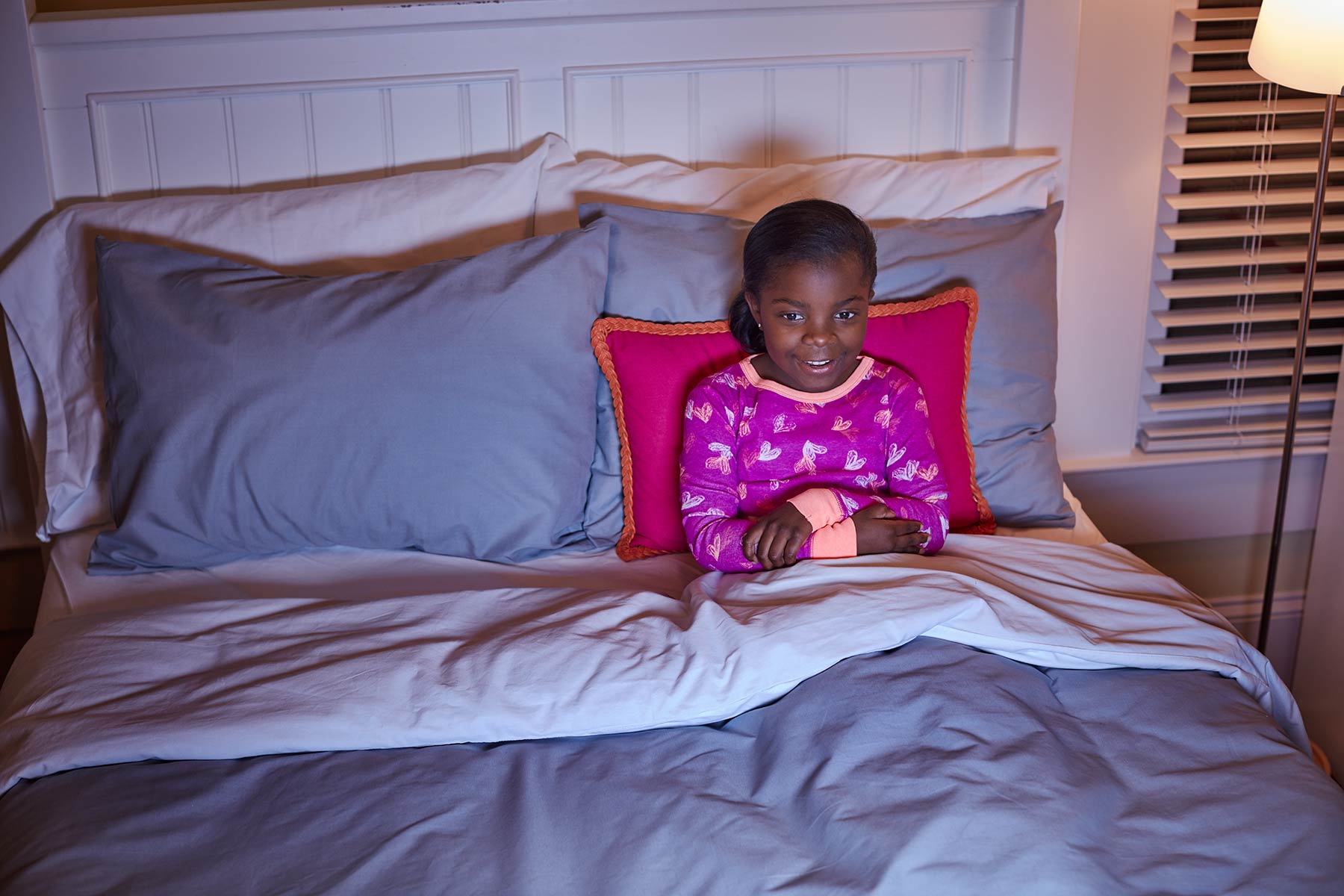 Girl in bed watching TV